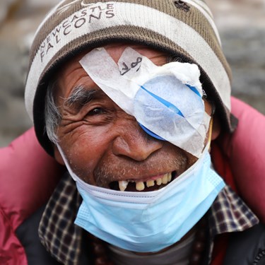 Person with eye patch, recovering from eye surgery